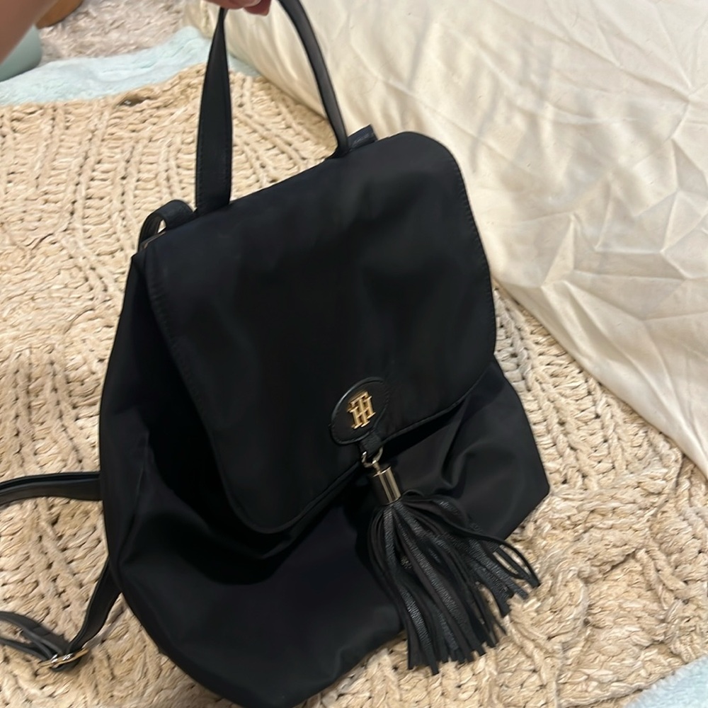 Great condition TOMMY HILFIGER backpack with leather tassel in the front.